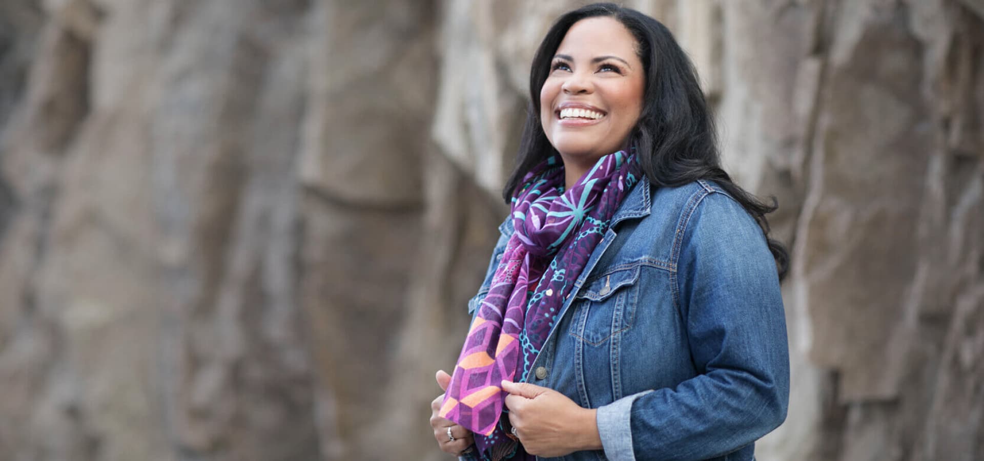 Patty Staco smiling outdoors in a purple scarf